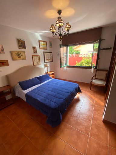 Habitación 2 Habitación luminosa con cama doble, decoración artística y ventana con vistas al exterior.